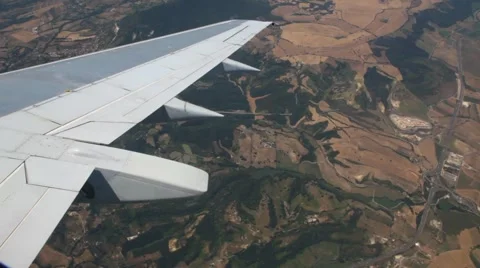View from window on wing of plane flying over mountains landscape Stock Footage 6378102