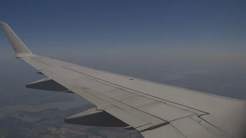 View From Window Wing From Plane Flying Over Fields In Blue Sky Stock Footage 118096052
