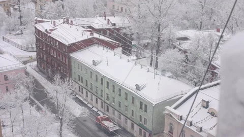 View from window winter urban landscape with falling snowflakes Video stock 323505260