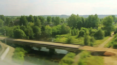 View from the windows of high-speed trains on the village below (POV) Видео 27291493