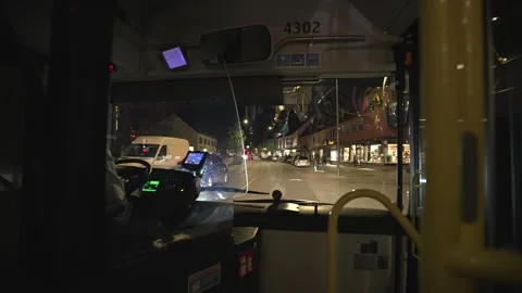 View from the windshield of a bus on the road in the night city of Munich Stockbeeldmateriaal 243379704