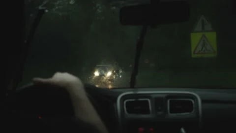 View of the windshield, the car is driving in the pouring rain on the road in Stock Footage 156820442
