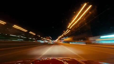 View from the windshield of a car on a ride in the night city, hyperlabs Stock Footage 243570544