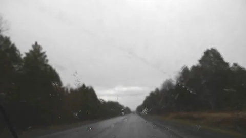View from the windshield of a car on an track . car wipers remove raindrops Stock-Footage 131588827