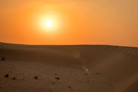 View of windy sand dunes deep in desert of Abu Dhabi - United Arab Emirates. Stock Photos