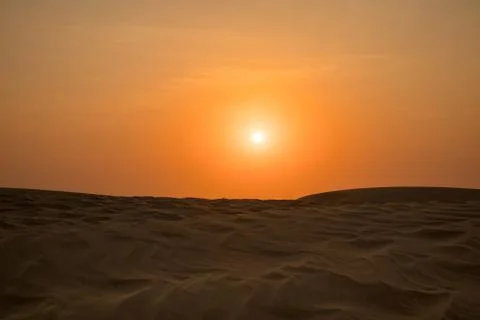 View of windy sand dunes deep in desert of Abu Dhabi - United Arab Emirates. Stock Photos
