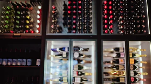 View of a wine storage wall with different sections filled with bottles Stock Footage 335561768