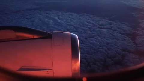 A view of the wing of an airplane with the clouds below Stock Footage 331358914