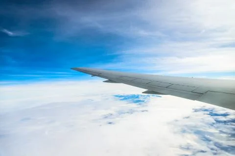 View of the wing of an airplane through the window Stock Photos