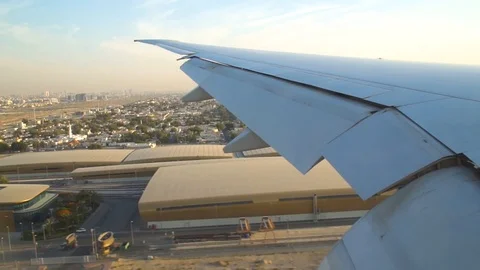 View of a wing of an airplane while is landing in Dubai Airport, UAE Stock Footage 114644215