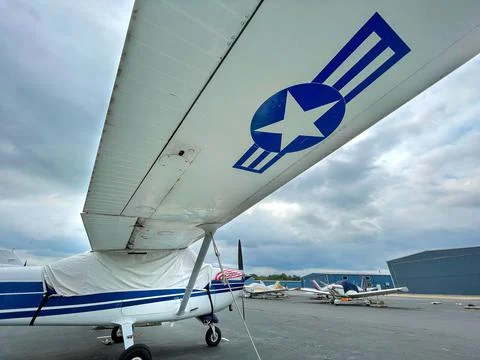 View of a wing and fuselage of a small private airplane. Stock Photos
