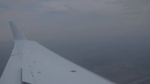 View Of Wing Of Plane Flying High Over Land Stock Footage 118616353