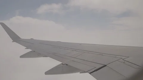 View Of Wing Of Plane Soaring Into A Cloudy Sky Stock Footage 118096085