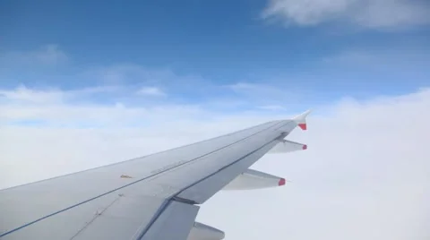 View of wing in sky out from flying airplane Stock Footage 977094