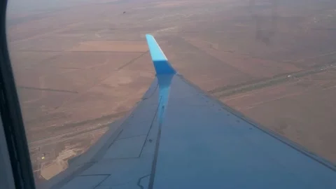 View of wing upper surface and vertical stabiliser of landing aircraft. Gournd Stock Footage 145831383