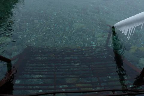 View of the winter beach with snow, an empty frame under umbrellas Stock Photos