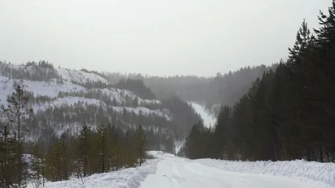 View of the winter road on a cloudy winter day on the mountainside. Footage 스톡 동영상 160724590