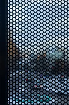 View of Winter Street in Sopot Through Perforated Metal Window Shutter Stock Photos