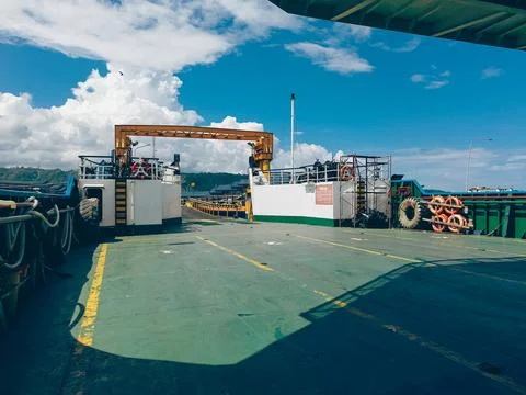 A view from within a ferry, looking out onto a bustling harbor scene Stock Photos