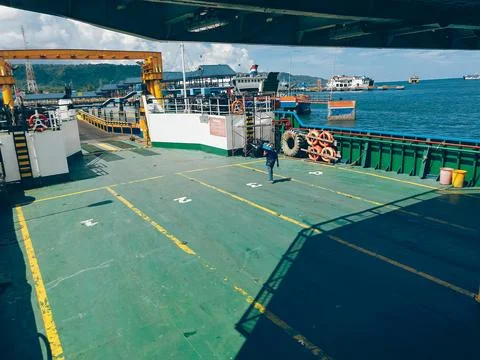 A view from within a ferry, looking out onto a bustling harbor scene Stock Photos