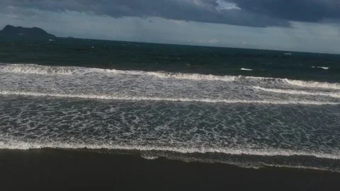 View a woman alone on the beach using a drone Video stock 235479984