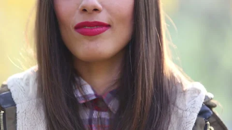 View of woman's mouth with red lipstick, smiling and singing with microphone Stock Footage 59556622