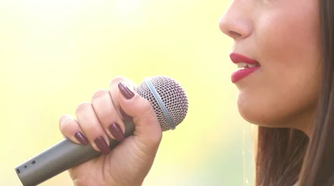 View of woman's mouth with red lipstick, smiling and singing with microphone Stock Footage 59556649