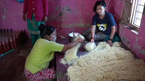 View of women processing noodles in a local workshop, Nepal. 스톡 동영상 335472282