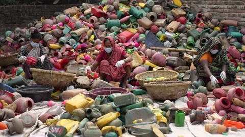 View of women sorting through a large pile of plastic waste, Bangladesh. Stock Footage 335464865
