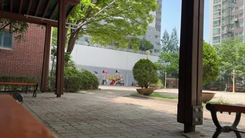 View from a Wooden Pavilion Overlooking an Empty Neighborhood Playground Stock Footage 338293618
