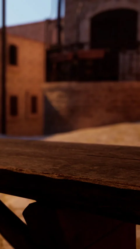View of a wooden table with a background of old buildings during sunset 動画素材 339510172