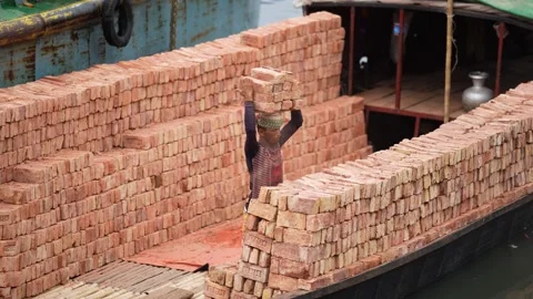 View of a worker carrying bricks on a boat in Aminbazar, Bangladesh. Stock Footage 334993818