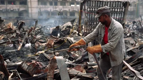 View of a worker cutting metal debris in Dhaka, Bangladesh. Video stock 335562743