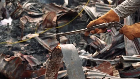 View of a worker cutting scrap metal with a torch, Bangladesh. Video stock 335562740