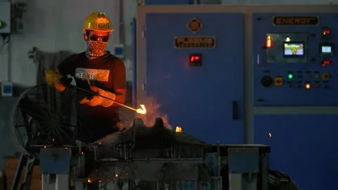 View of a worker handling molten metal in a factory, Bangladesh. Video stock 334951320