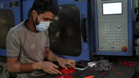 View of a worker operating an industrial machine in Jashore, Bangladesh. Video stock 335464975
