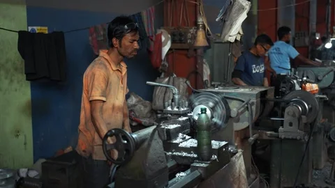 View of a worker operating a lathe machine in Bogura, Bangladesh. Video stock 334950263