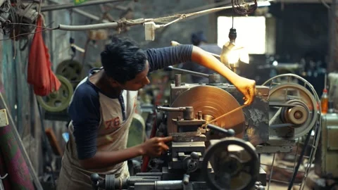 View of a worker operating a lathe machine in a workshop, Bangladesh. Video stock 335584757