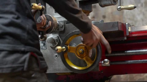 View of a worker operating a manual lathe machine in Bangladesh. Video stock 335584590