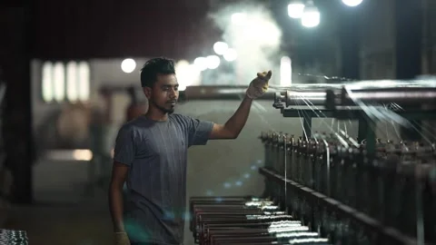 View of a worker operating a textile machine in Bogura, Bangladesh. Video stock 334950448