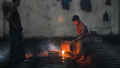 View of a worker pouring molten metal in a foundry, Bangladesh. 스톡 동영상 334950923