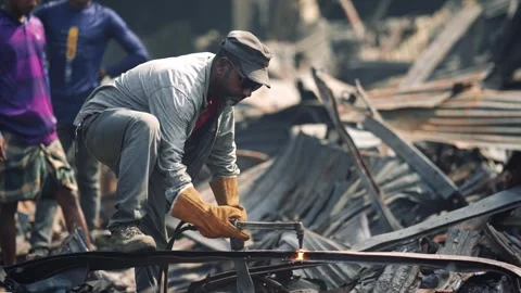 View of a worker using a cutting torch on metal debris, Bangladesh. Stock Footage 335600341
