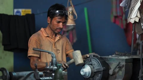 View of a worker using a wooden mallet in a workshop, Bangladesh. Stock Footage 334950215