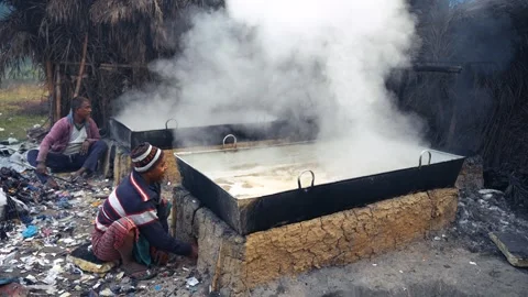 View of workers boiling date juice in large pans, Bangladesh. Stock Footage 335653276