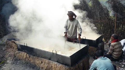 View of workers boiling juice in large vats in Natore, Bangladesh. Stock Footage 335653079