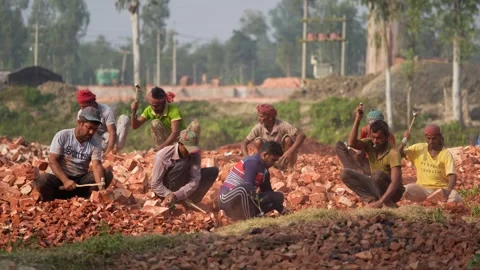View of workers breaking bricks in Bogura, Bangladesh. Video stock 334981008