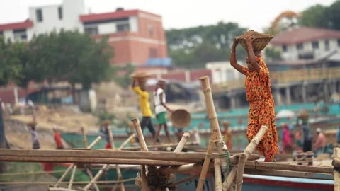 View of workers carrying baskets at Aminbazar river port, Bangladesh. Stock Footage 334993424
