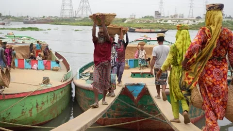 View of workers carrying baskets from boats at Aminbazar, Bangladesh. Video stock 334994922