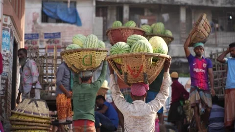 View of workers carrying baskets of watermelons in Dhaka, Bangladesh. Video stock 335008077