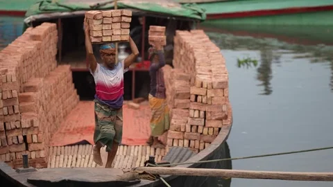 View of workers carrying bricks on a boat in Aminbazar, Bangladesh. 動画素材 334993735